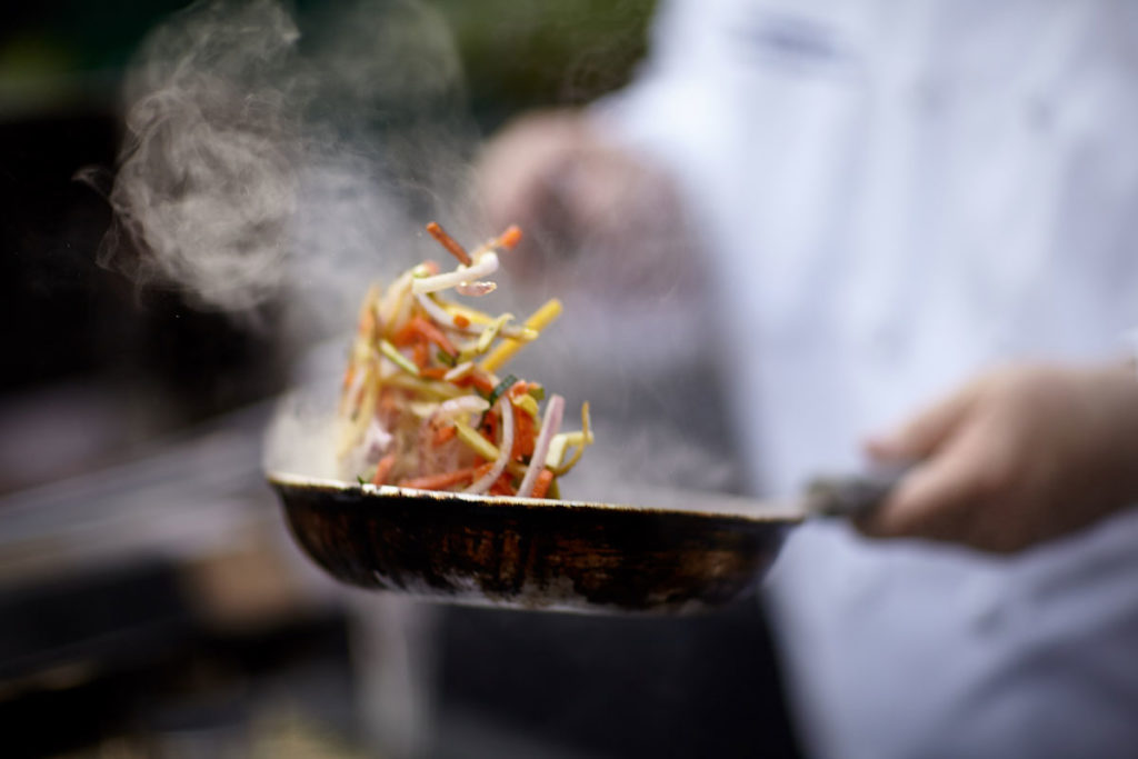Chef flipping food in a pan