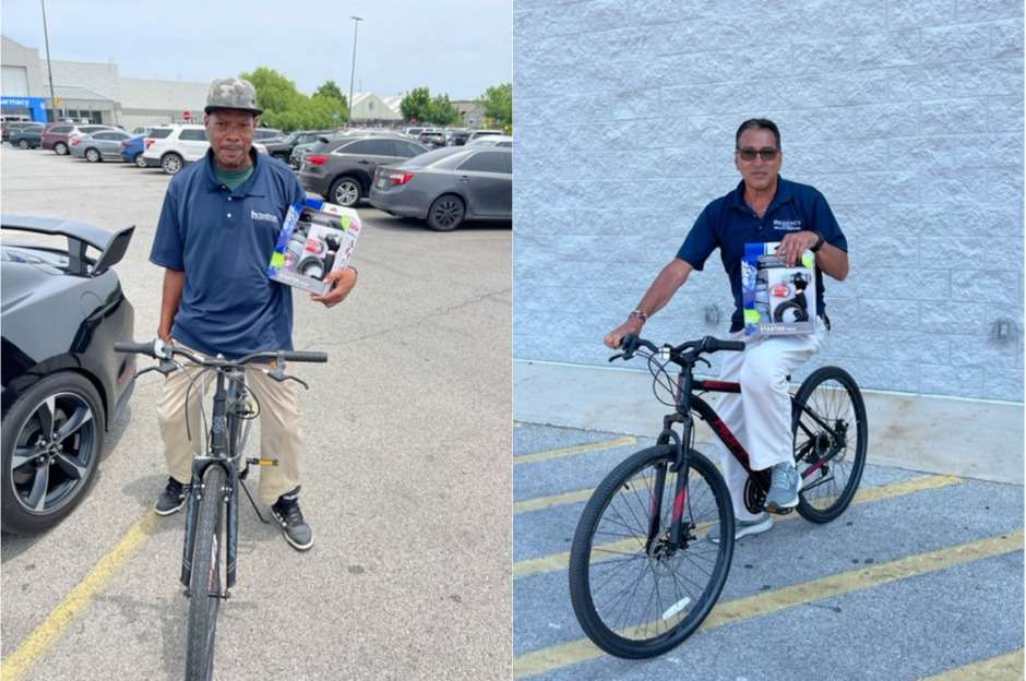 HCSG Housekeepers, Charleston Hayden and Terry Benitez, sitting on their bikes, holding bike kits.