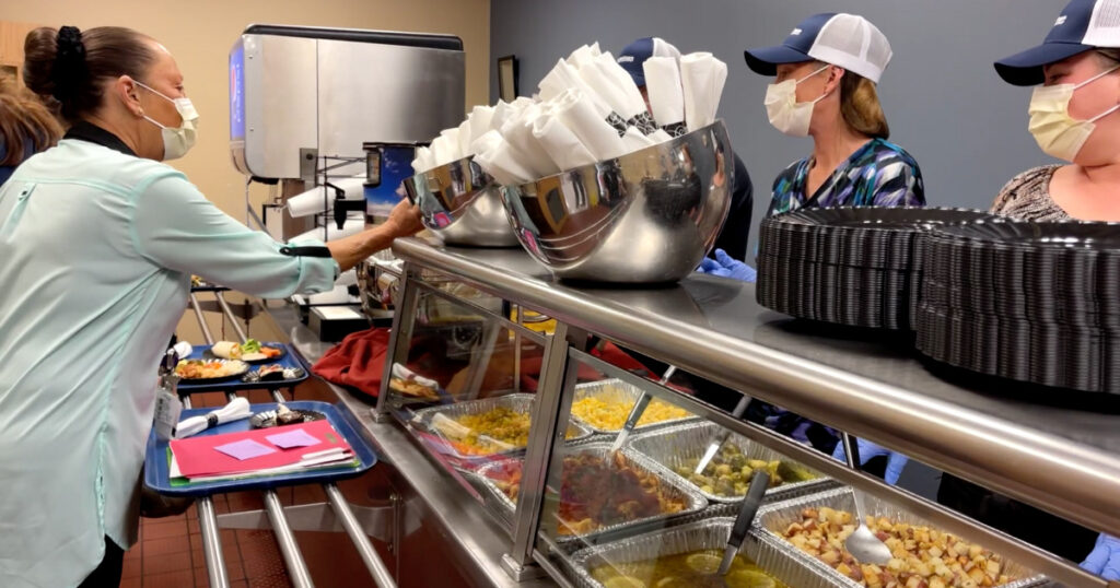 HCSG team members serving food at a Taste of HCSG event in Indiana.