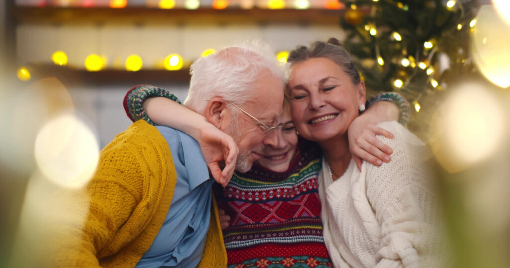 young boy hugging grandparents