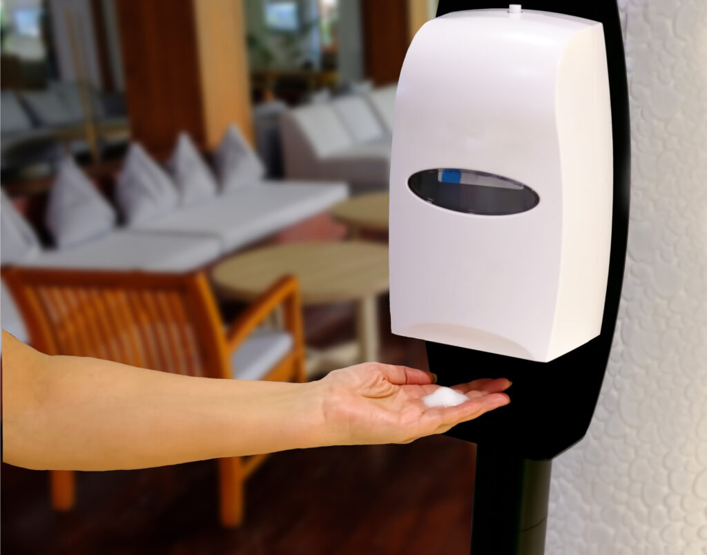 A sanitizer dispenser on a wall