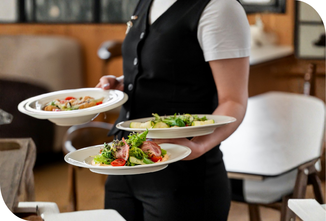 Smiling caregiver warmly interacts with a senior woman in a healthcare setting. Compassionate care and positive engagement in a senior living community.